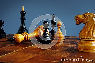 Win in business competition. Success in challenge. Pawn and king on chess board Stock Photo