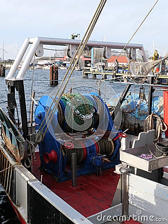 Winch for hauling in the trawl net on a fishing cutter in the harbor Stock Photo