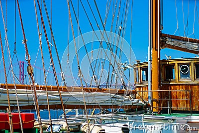 Winch and rope on an old wooden sailboat yacht with teak and pulleys . Stock Photo