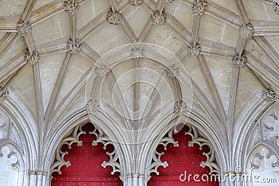 WINCHESTER, UK: Detail of the main entrance to the Cathedral with red doors and arches Stock Photo