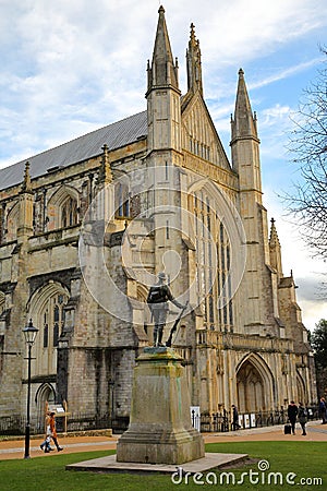 WINCHESTER, UK - FEBRUARY 4, 2017: Exterior view of the Cathedral with the statue of First World War Soldier in the foreground Editorial Stock Photo