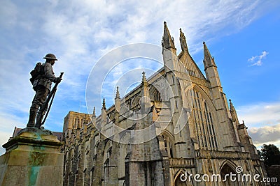 WINCHESTER, UK - FEBRUARY 4, 2017: Exterior view of the Cathedral with the statue of First World War Soldier in the foreground Editorial Stock Photo