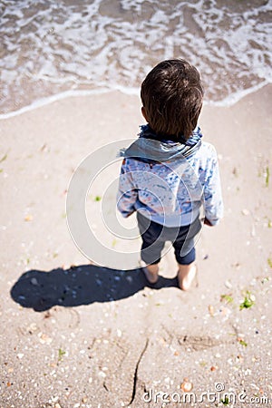 Wind blowing little boy's hair and scarf Stock Photo
