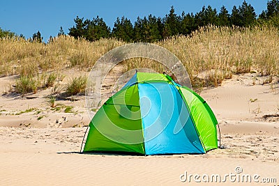 Wind breaker tent on a sandy beach by the sea. Nobody. Colorful tent protection from wind and sunburn Stock Photo