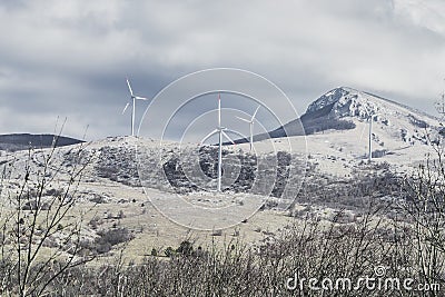 Wind farm with energy converters in a mountainous area Stock Photo