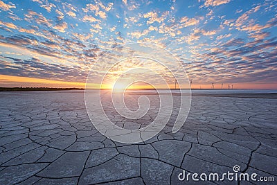 Wind farm and the salted lake Syvash at sunset light, scenic industrial and nature landscape, Kherson oblast, Ukraine Stock Photo