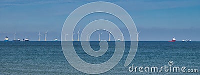 Wind farm turbines and support ships off the coast of Aberdeen in Scotland, UK Editorial Stock Photo