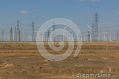 Wind power plants and electric pylons in the Gobi desert, Gansu province, Chi Stock Photo