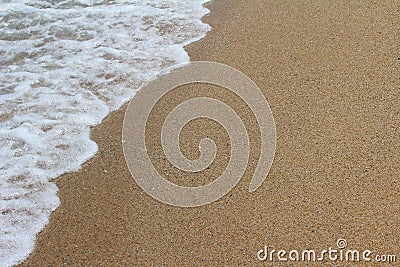The wind rolls small waves on a sandy beach. Summer sea backgrou Stock Photo