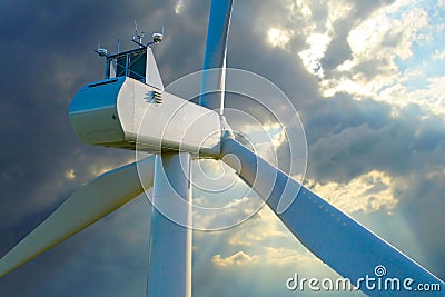 Wind turbine against stormy sky. Stock Photo