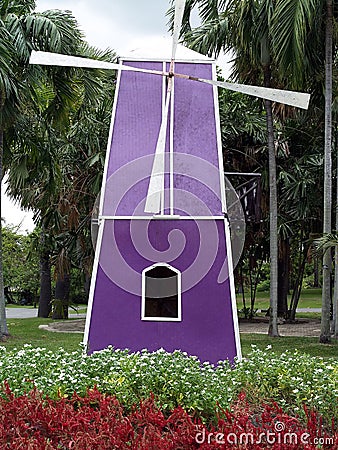 purple bamboo woven wind turbine tower among flower gardens in public park Stock Photo