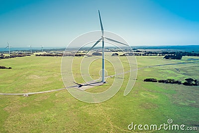 Wind turbine standing tall in harsh sunlight. Stock Photo