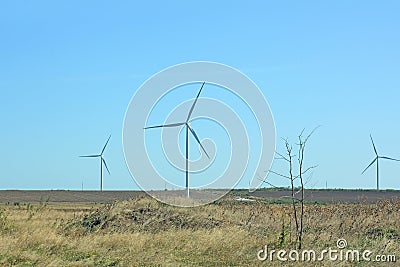 Wind turbines energy converters on the nature background Stock Photo