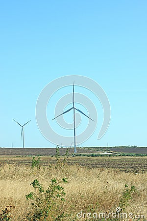 Wind turbines energy converters on the nature background Stock Photo