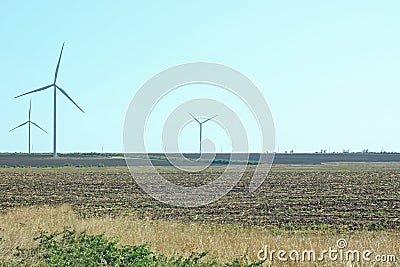 Wind turbines energy converters on the nature background Stock Photo