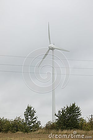 Wind turbines field in a stormy day with strong wind and rain. Wind farm eco field. Green ecological power Stock Photo