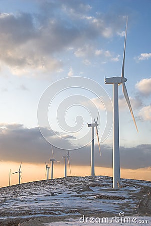 Wind turbines on a mountain with snow Stock Photo