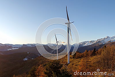 Wind turbines in mountains, Alps, Italy Stock Photo