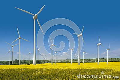 Wind turbines in a rapeseed field Stock Photo
