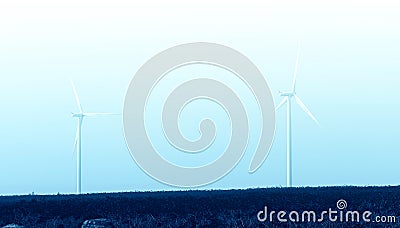 Wind turbines on sky in blue color filter Stock Photo