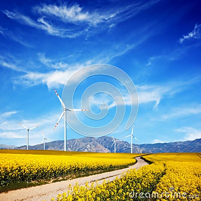 Wind turbines on spring field. Alternative, clean energy Stock Photo