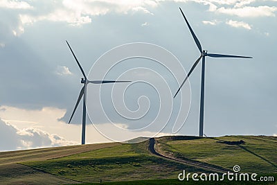 Wind turbines or windmills in the rolling farm fields of the Palouse in Washington State Stock Photo
