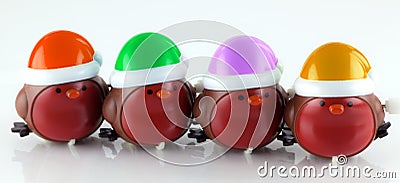 Wind up robins with colorful hats Stock Photo