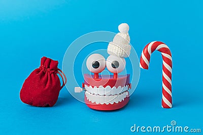 A wind-up toy in a hat, a bag with gifts and a New Year's candy Stock Photo