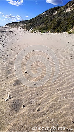 Windblown sand with dunes and blue sky Stock Photo