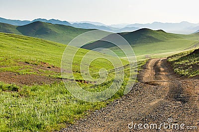 Winding dirt road through Central Mongolian steppe Stock Photo