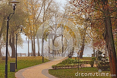 Winding path in the autumn park. The concept of foggy weather in the city. Foggy autumn morning in the Park Natalka Editorial Stock Photo
