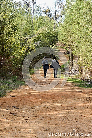 Winding path with two girls walking Editorial Stock Photo