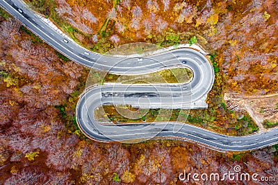 Winding road in the forest. Aerial view in the middle of autumn Stock Photo