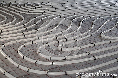 Winding tubes of the hydronic radiant heating system on the floor Stock Photo