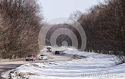 Winding winter road in the forest on a sunny day. Stock Photo