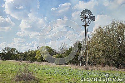 Windmill and bluebonnets in the Texas Hill Country Stock Photo