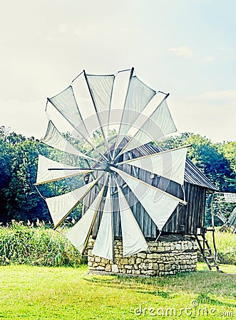 Windmill close up, green forest, wild vegetation Stock Photo