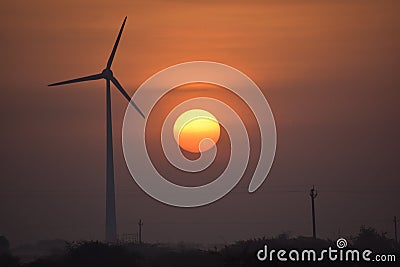 Windmill energy and the morning sunrise in city Dwarka Stock Photo