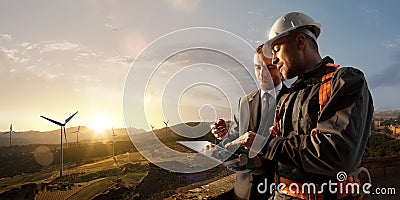 Windmill engineer and businessman planing new ecology project. they standing and looking in tablet. Around wind generators Stock Photo