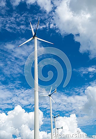 Windmill farm for alternative clean energy with clouds and blue Stock Photo