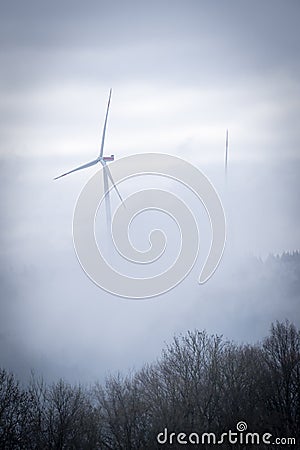 Windmill in a foggy forest Stock Photo