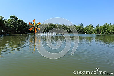 Windmill and lake Stock Photo