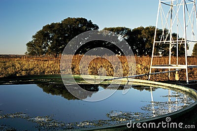 Windmill & Stock Tank on a ranch in Texas Stock Photo