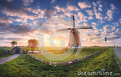 Windmill at sunrise in Netherlands. Spring panoramic landscape Stock Photo