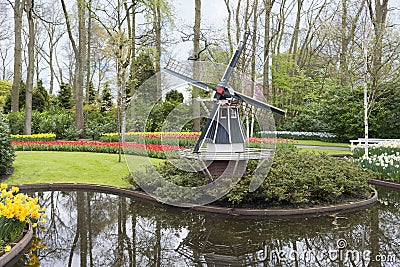 Windmill and tulips in dutch Keukenhof Stock Photo