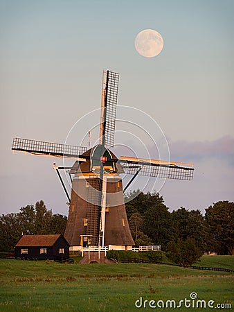 Windmill under a full moon Stock Photo