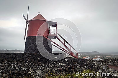 Windmill vineyards with lava wall on the island of Pico entered in the UNESCO World Heritage Site Stock Photo