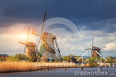 Windmills against cloudy sky at sunset in Kinderdijk, Netherland Stock Photo