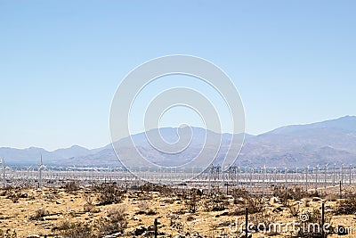 Windmills along a desert landscape Stock Photo