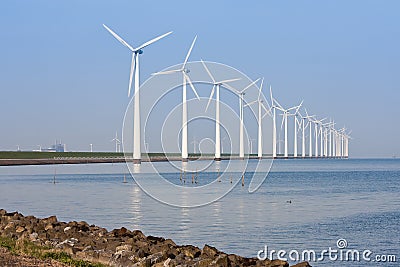 Windmills mirroring in the calm sea Stock Photo